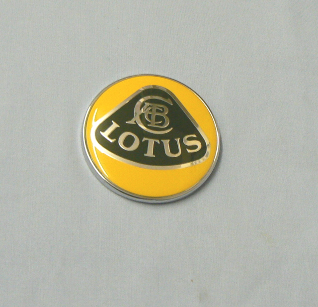 B117U0346F (117U0346) ROUND LOTUS BADGE on REAR PANEL (Prior 2005)